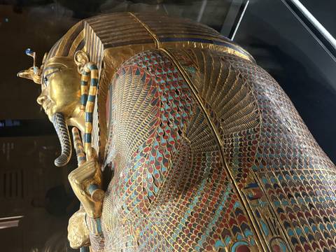 Detail of Tutankhamun’s colorful feather-patterned sarcophagus side with gold and enamel inlays.