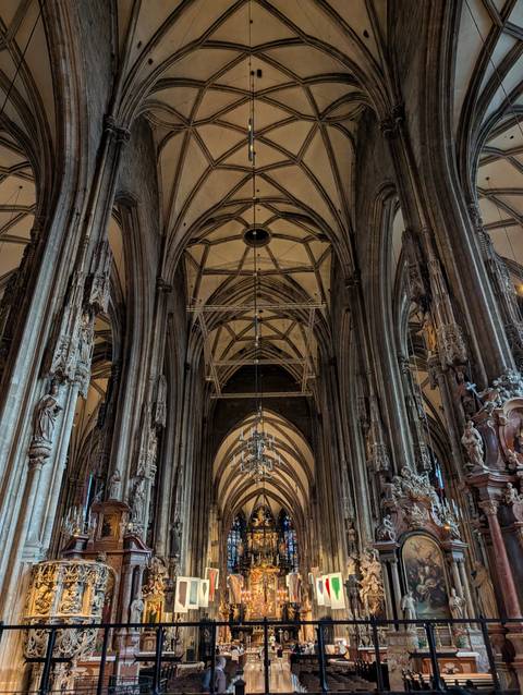 Looking up at soaring Gothic arches and columns inside a grand cathedral