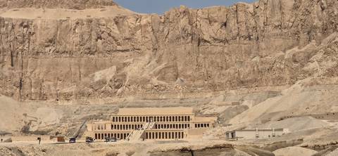Temple of Hatshepsut nestled beneath towering limestone cliffs in the Theban hills