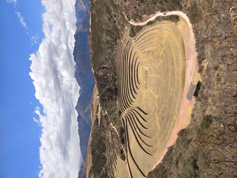 Circular agricultural terraces of Moray set against a dramatic Andean backdrop