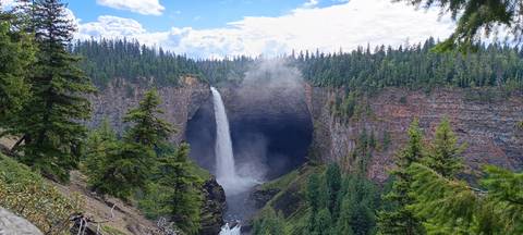 Dramatic Helmcken Falls plunging into a misty canyon amid dense forest