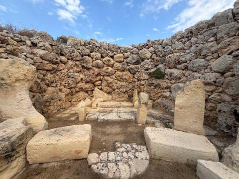 Ancient megalith stone temple remains with stacked weathered rocks under blue sky