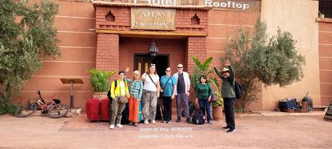 Group photo with luggage outside Atlas Gorge Dades hotel entrance; timestamp text overlay present.