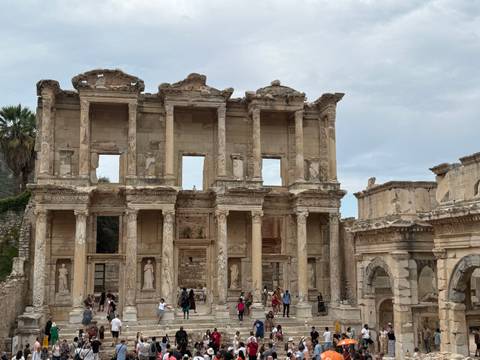 Grand façade of the Library of Celsus in Ephesus with tourists below