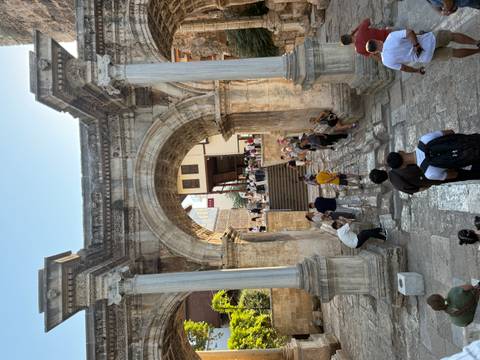 Crowds passing through the triple-arched Roman Hadrian’s Gate in Antalya