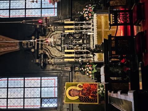 Intricate chapel altar featuring the revered Black Madonna icon surrounded by tall candles and gilded décor.