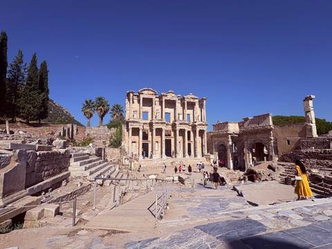 ancient Library of Celsus ruins in Ephesus with tourists exploring under clear sky