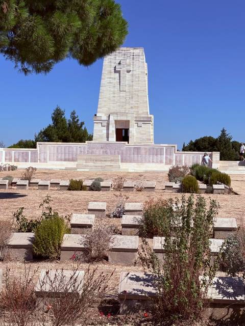 war memorial monument with stone walls and trimmed shrubbery at Gallipoli site