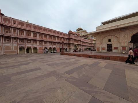 Spacious courtyard of Jaipur’s City Palace with its pastel pink Rajasthani facades.