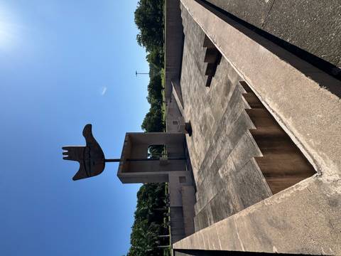 Iconic Open Hand Monument rising against a clear blue sky above a concrete plaza.