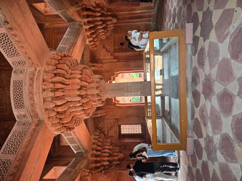 Central carved stone pillar with elaborate capital inside the Diwan-i-Khas of Fatehpur Sikri.