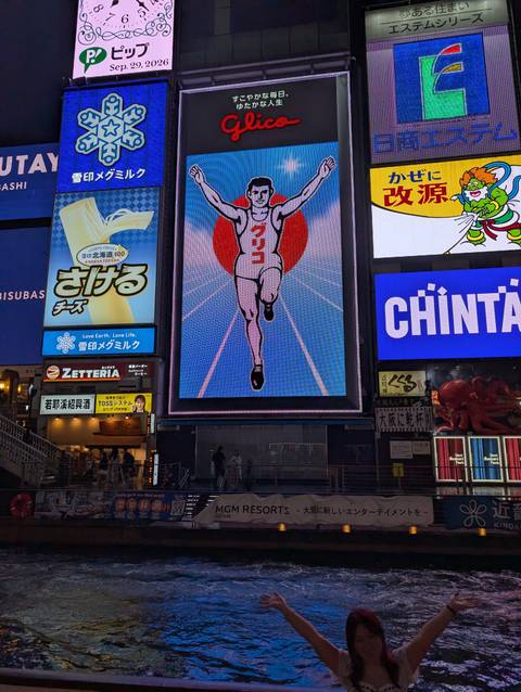 Night view of neon billboards in a bustling entertainment district featuring the famous running man sign