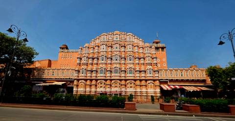 Iconic honeycomb façade of the Hawa Mahal against a deep blue sky