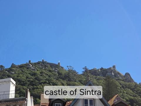 Hilltop stone fortress walls spanning a ridge under blue sky with caption overlay across the bottom