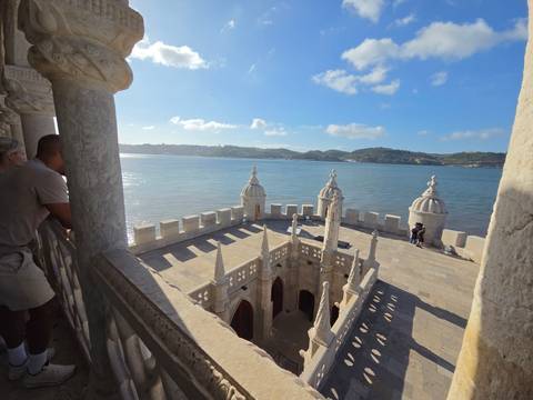 Rooftop terrace of Belém Tower overlooking the Tagus River with visitors enjoying the panoramic view
