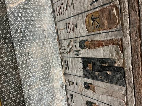 Egyptian tomb ceiling with geometric star pattern and painted deities