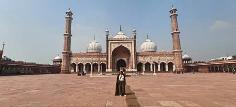Traveller standing in the vast courtyard of Jama Masjid mosque in Delhi