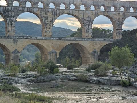 Impressive multi-level Roman stone aqueduct spanning a river valley