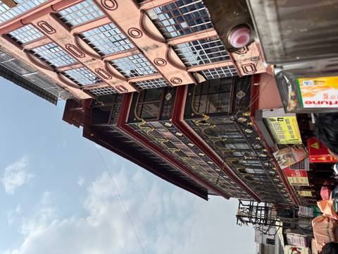 Colorful multi-storey commercial building and street signs in a busy Indian market