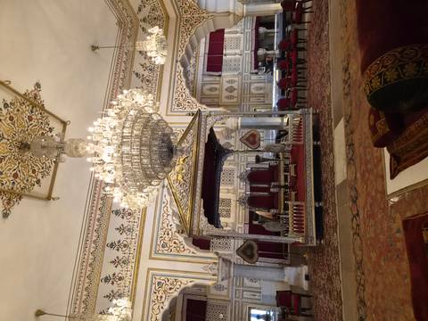 Opulent palace hall with grand chandeliers, silver throne and ornate decor