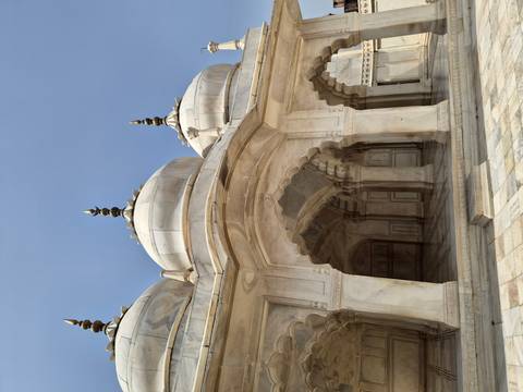 Elegant white marble mosque pavilion with three domes and scalloped arches
