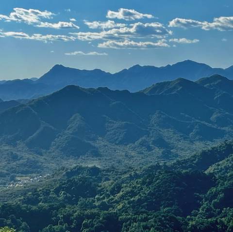 Blue-green mountain ridges stretch into the distance beneath a clear sky.