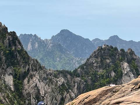 Jagged granite peaks of Seoraksan National Park rise sharply against a blue sky.