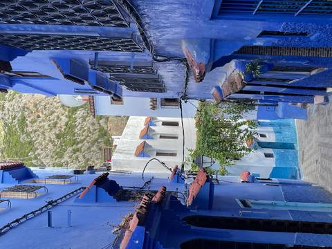 A narrow blue-washed alleyway winds through the hillside medina of Chefchaouen.