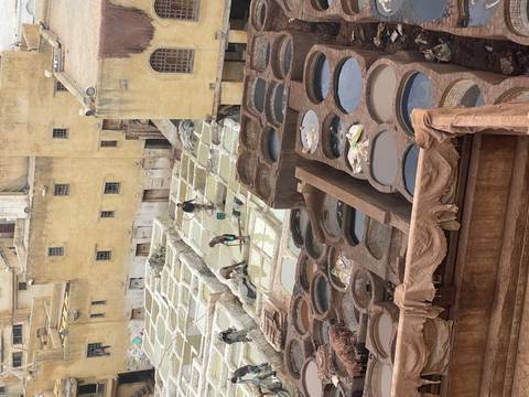 Workers tend vats in the centuries-old Chouara tannery, Fes, viewed from above.
