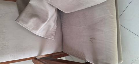 Upholstered chair cushion with visible stains and marks.