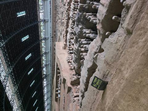 Expansive hall housing rows of Terracotta Warriors still in situ beneath a vast steel roof.