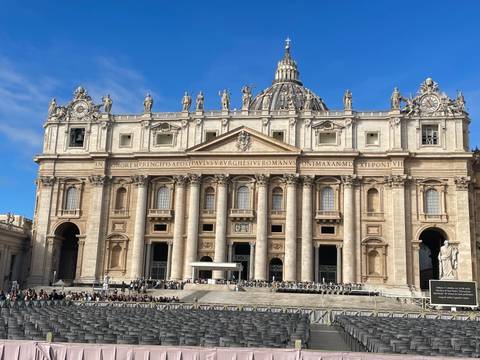 St. Peter’s Basilica dominates Vatican City’s square, towering statues and ornate façade gleaming in afternoon light.