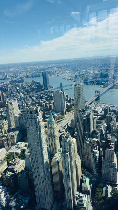 High-angle view over Manhattan skyscrapers with Brooklyn and Manhattan Bridges spanning the East River