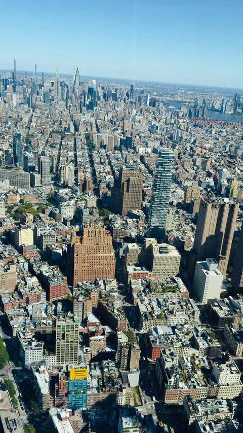 Dense grid of downtown Manhattan buildings captured from above on a clear day