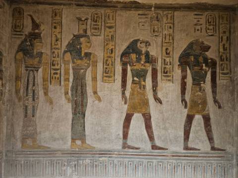 Well-preserved wall painting of four ancient Egyptian deities with hieroglyphic columns.