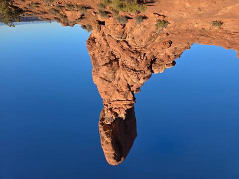 Balanced Rock rises dramatically against a deep blue sky in Arches National Park.