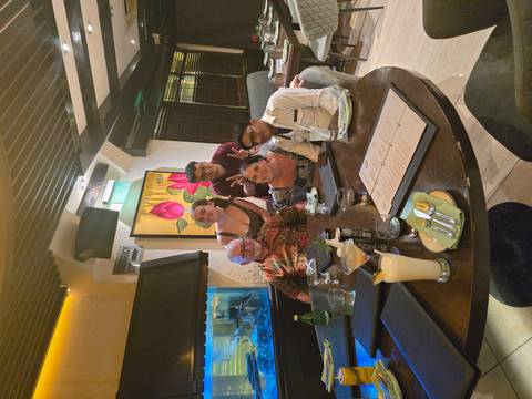 Friends gathered around a dinner table in a modern restaurant.