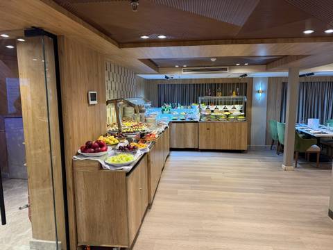Well-stocked buffet line with colorful fruit and desserts aboard a Nile cruise ship restaurant.