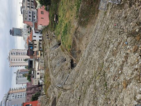 Ruins of ancient arena slope amid modern city buildings in Durres.
