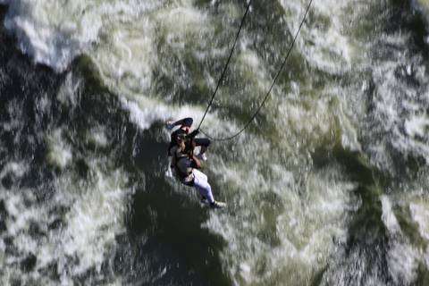 A tandem swing pair seen from above as they skim over rapids below.