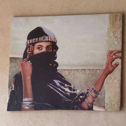 Painting of a veiled Berber woman adorned with traditional jewelry.