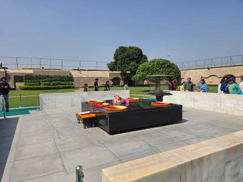 Visitors observe the black marble memorial and floral tributes at Raj Ghat in Delhi.