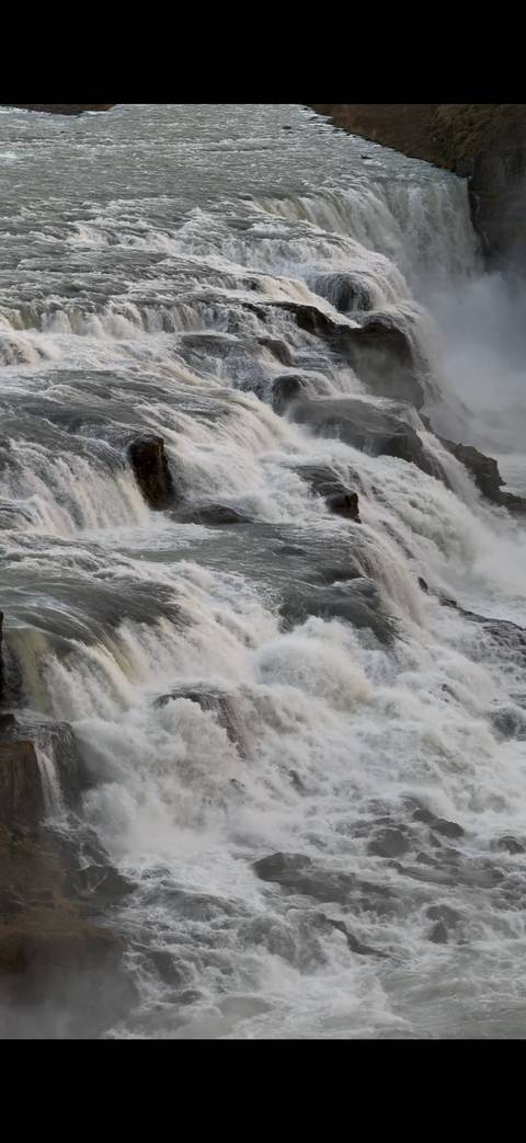 Powerful cascading water of Gullfoss waterfall captured in close detail.