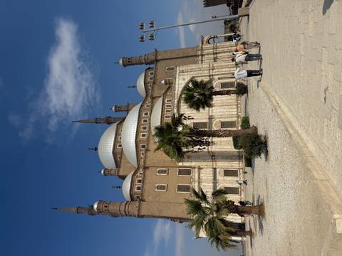 Grand Ottoman-style Mosque of Muhammad Ali dominates the Cairo Citadel under a bright sky.