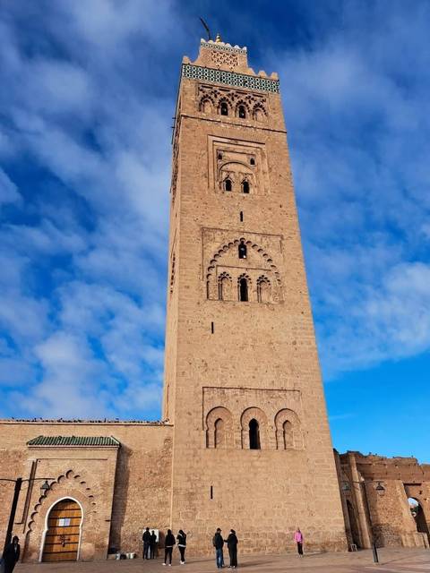 Tall minaret of the Koutoubia Mosque rising against a blue sky in Marrakech