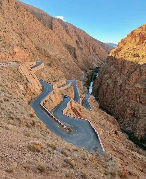 Famous winding mountain road through the dramatic Dades Gorge with river below