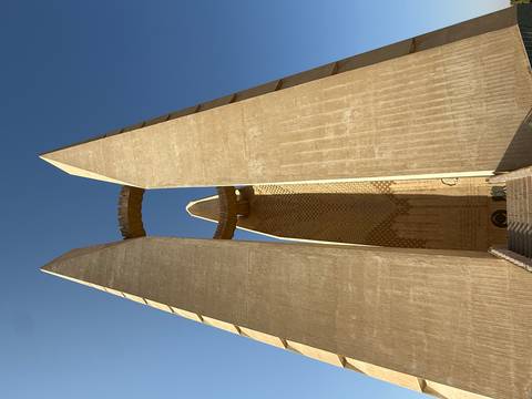 Tall twin pylons of the 6th October War Panorama memorial reaching into blue sky