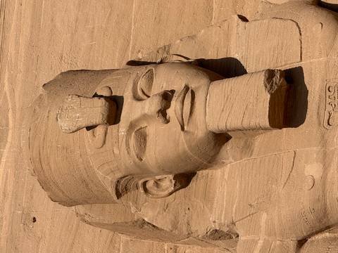 Detailed close-up of a Pharaoh's head sculpture at Abu Simbel