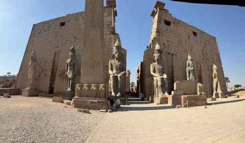 Grand entrance of Luxor Temple lined with massive statues and obelisk