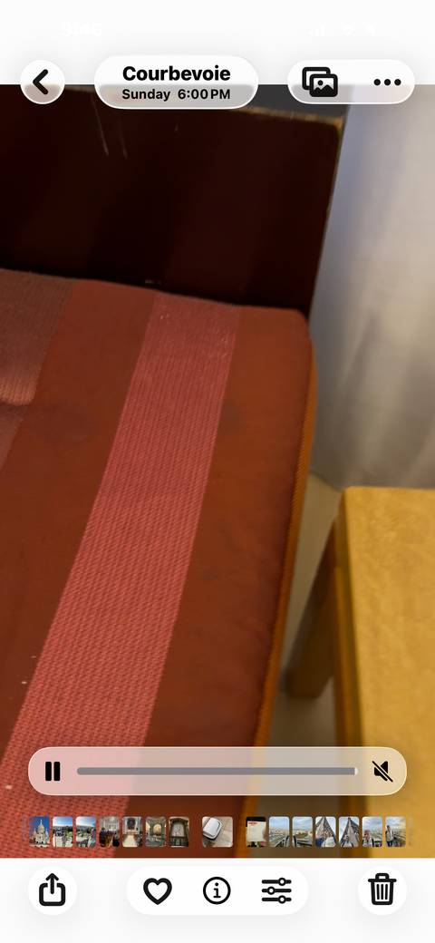 Blurry close-up of a red and brown fabric seat.